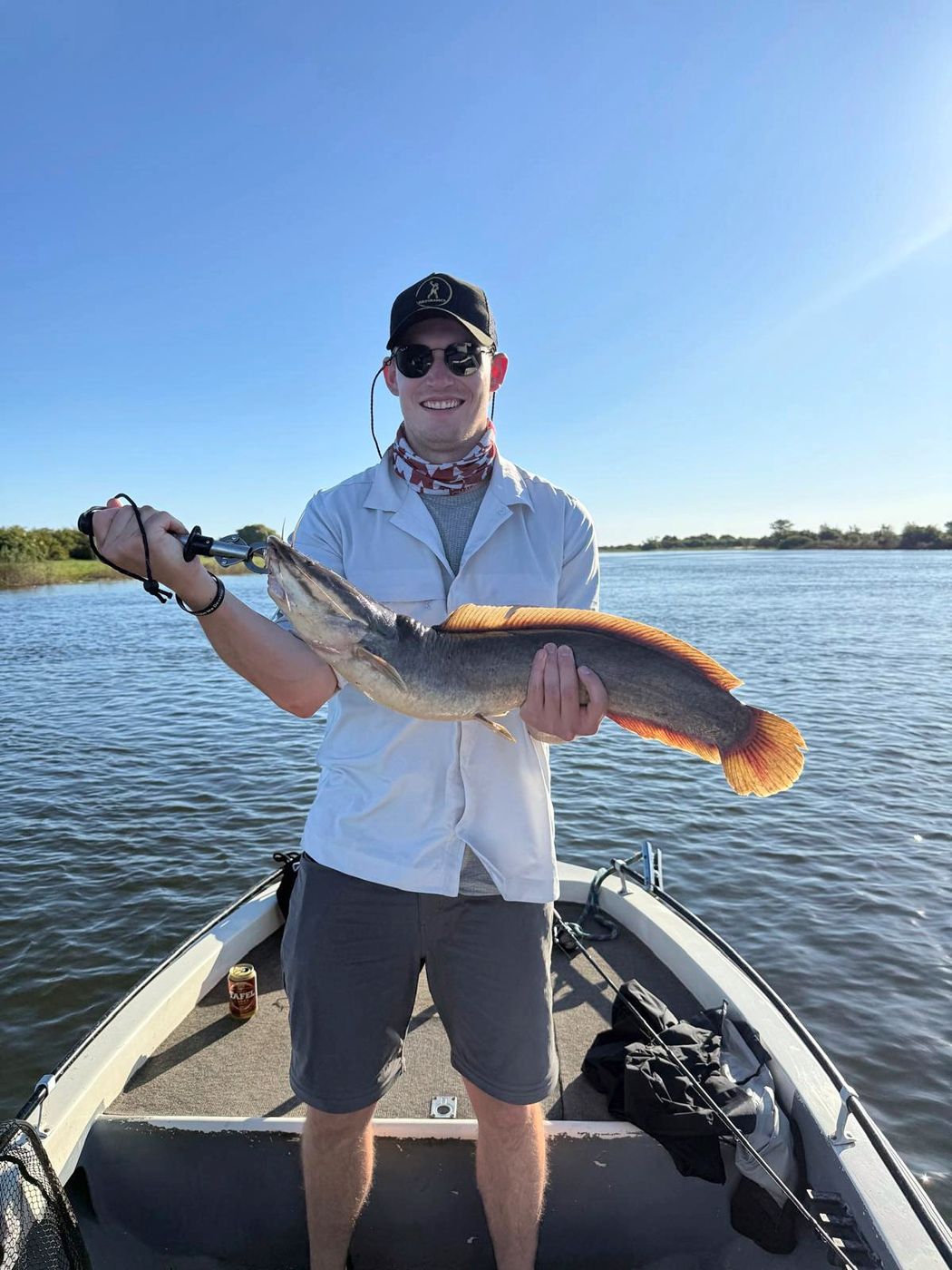Angler with a catfish on the boat