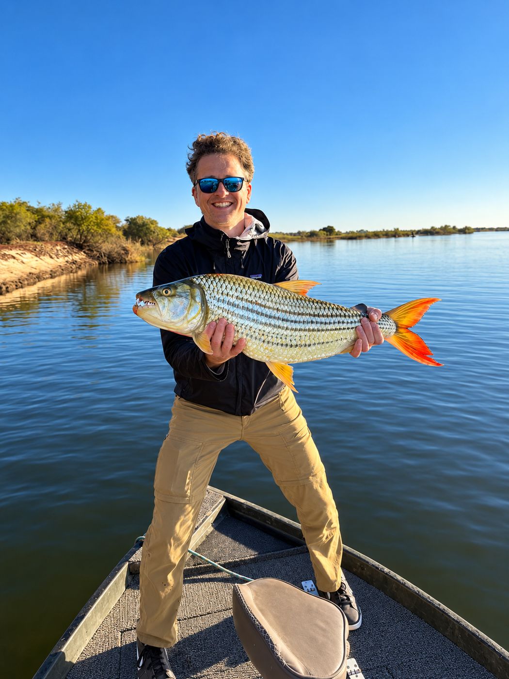 Young angler with a tigerfish on the boat
