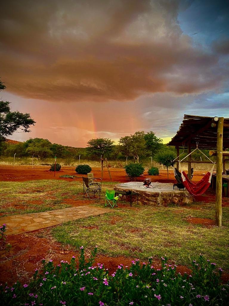 Lodge fire pit under a rainbow